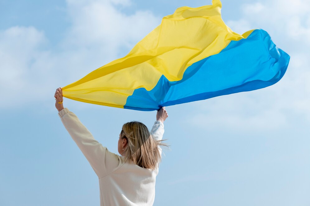 medium shot woman holding ukranian flag 23 2149363523